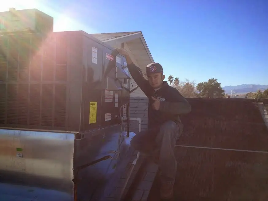 HVAC technician performing HVAC Inspection on a rooftop unit in Salmon Creek